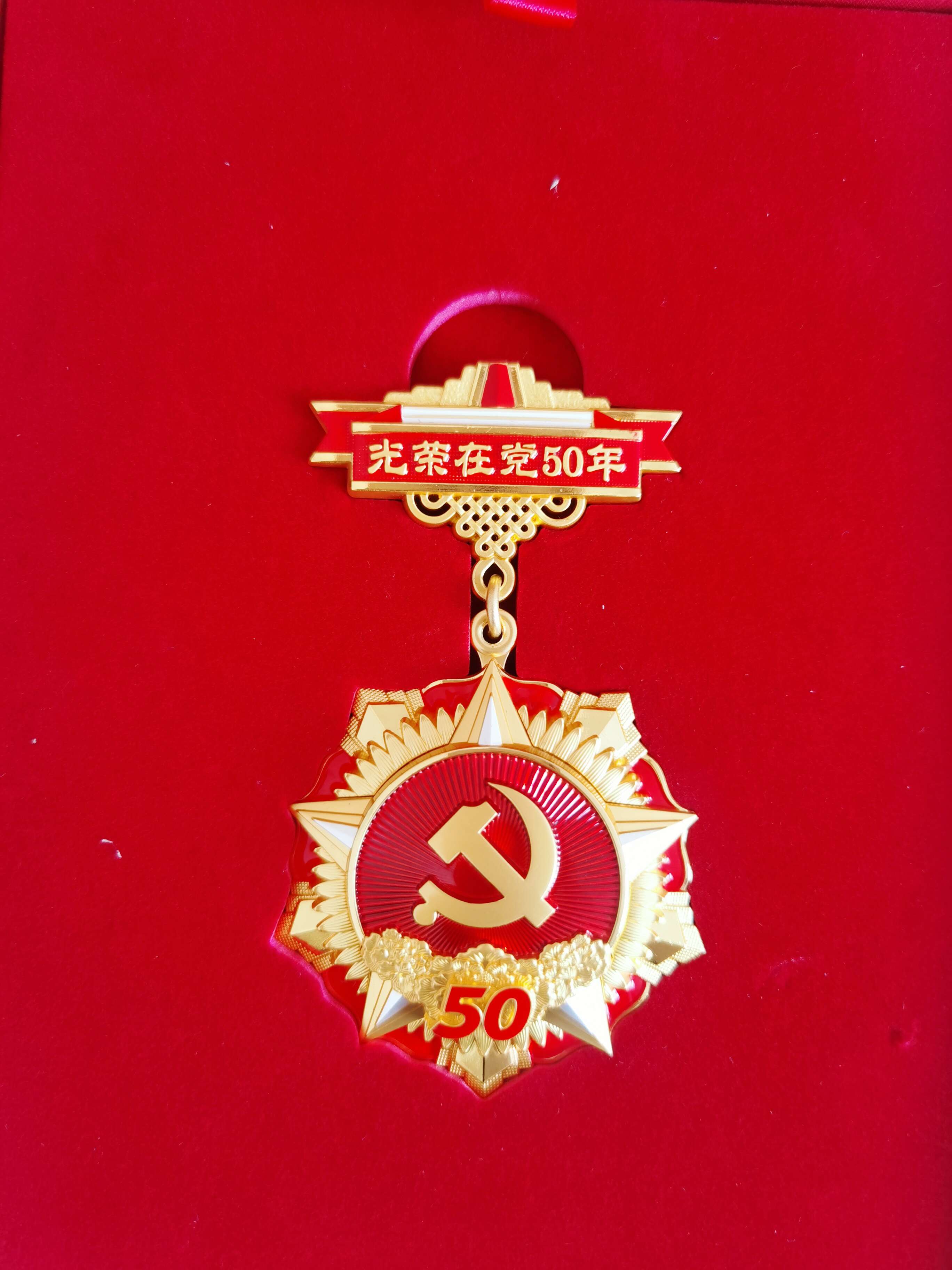 光榮在黨50年紀念獎章正面。 閆慧/攝